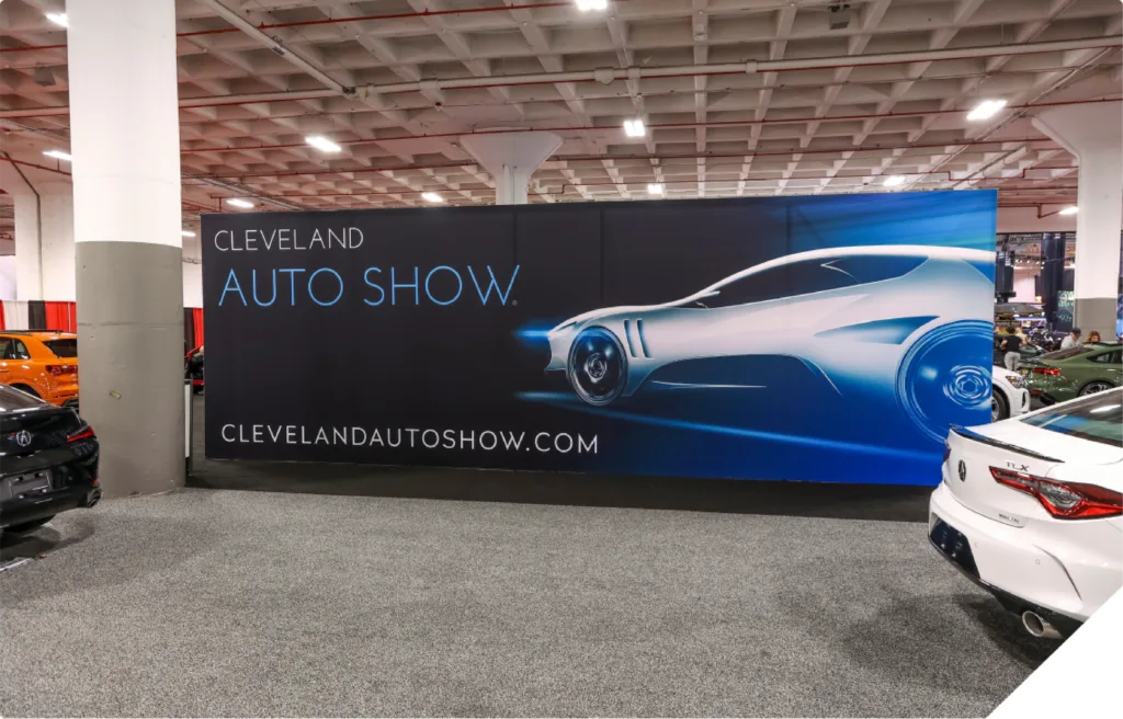 Image of a banner in a parking announcing Clevelan Auto Show